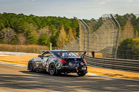 The dark blue 2007 Nissan 350Z cornering on track