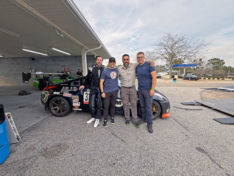 The Plan Z Motorsports team with the 2007 Nissan 350Z in the paddock
