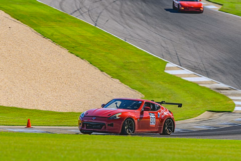 Plan Z Motorsports' red 2011 Nissan 370Z endurance racer on track