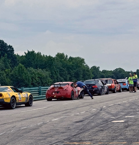 The red 2011 Nissan 370Z racing on track