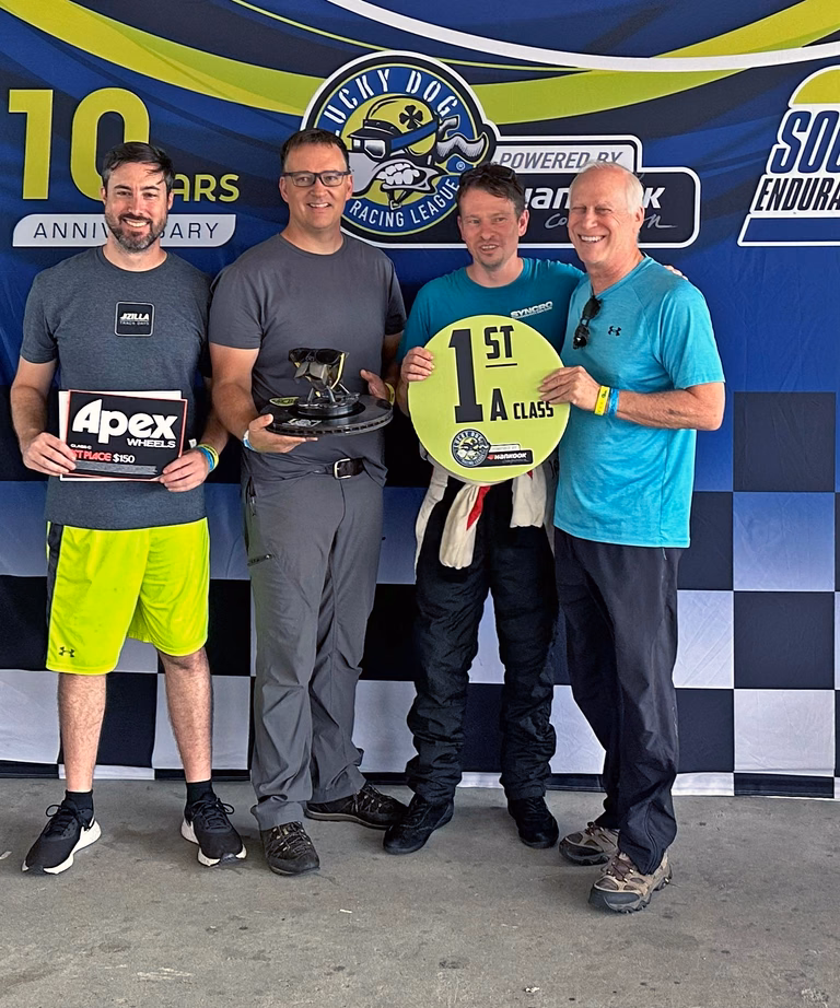 A Plan Z Motorsports driver on the podium after a race win